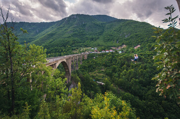 Durmitor,Montenegro, Tara Bridge, blonde woman zip line, adrenaline rush, across river canyon