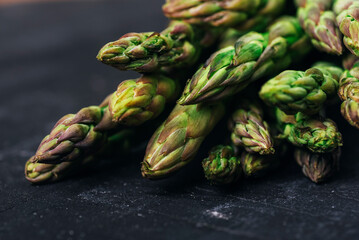 Fresh green asparagus on black background. Healty food, closeup