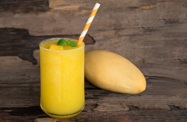 Mango juice fruit smoothies yogurt drink yellow healthy delicious taste in a glass slush for weight loss on wooden background.
