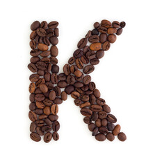 Capital letter K made from coffee beans. Coffee font. Alphabet made from coffee beans. White background. Roasted coffee beans.