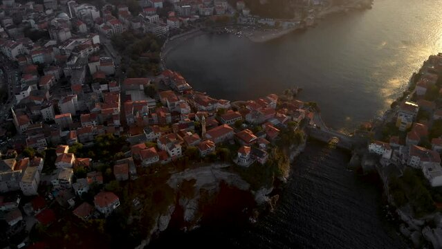 Aerial reveal shot of Amasra city coastline at sunset. Turkish province Bartin of the Black sea region