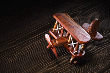 Wood toy plane on rustic wooden table.
