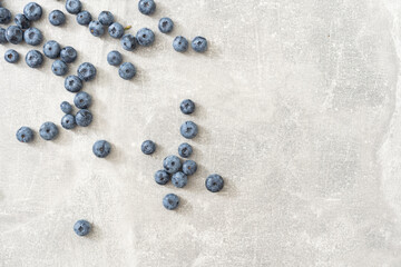 Fresh blueberries on gray background. Blueberries background. Healthy berry, organic food, antioxidant, vitamin, blue food.