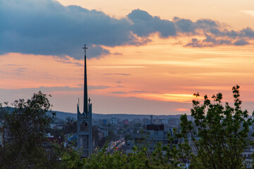 Fototapeta premium Sunset over horizon and church in foreground