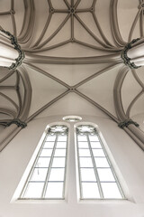 Fototapeta premium Bright interior of the church with stained-glass windows, view from below.