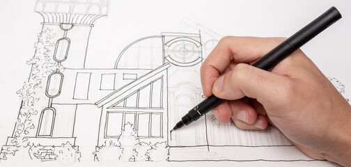 Making an architectural sketch with a pen.