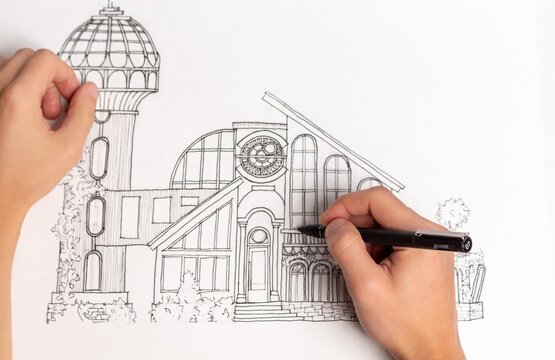 Making an architectural sketch with a pen.