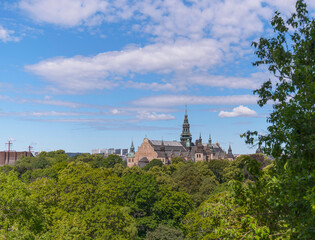 Fototapeta na wymiar Panorama view, old gothic museum building and tree and house skyline a sunny summer day in Stockholm