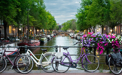 Fototapeta na wymiar Decorative bikes and flowers in Amsterdam Netherlands with view on river Amstel.