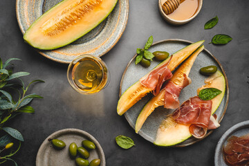 Jamon serrano, ham or prosciutto with melon and olives, a traditional Spanish and Italian appetizer...