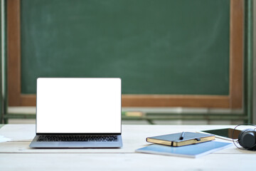 Mock up laptop screen on teacher desk at school background. Mockup bank empty computer display for students study programs. Online learning digital technology, remote distance e education classes.