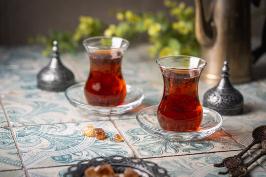 Turkish tea in traditional glass closeup on tile background