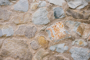The wall is beige. Decorative brick. The texture of the stone. Abstract background.
