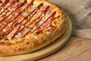 pizza on a tray on a wooden background close up