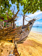 Old wooden pirate boat on the beach in Koh Phayam, Ranong, Thailand