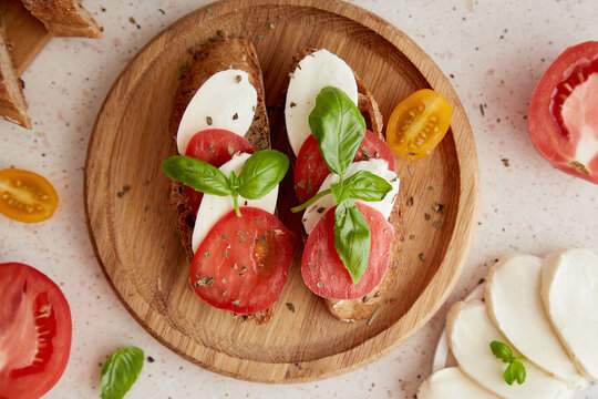 Homemade Caprese Sandwich, Italian Starter With Fresh Mozzarella, Tomatoes, Basil Leaves Close Up. Mediterranean Classic Recipe. View From Above Food.