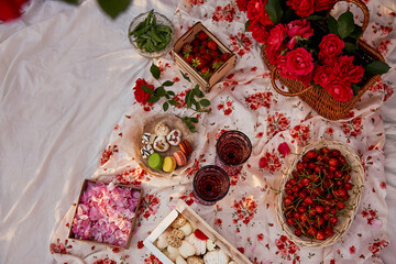 Summer aesthetic pink picnic with tablecloth marshmallows, macaroons, peas, strawberries, glasses...