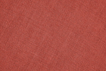 Pale red woven surface close-up. Linen net texture. Dark fabric len background. Textured braided...