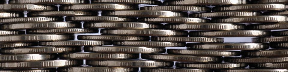 Money wall. Chaotic pile of coins close-up. Nickel coin texture. Business banner made of many coin edges. Economy finance and bank header. Tax and credit. Macro