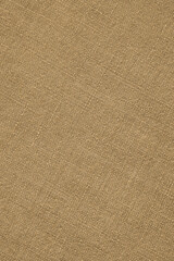 Fototapeta na wymiar Light brown woven surface close-up. Linen textile vertical texture. Fabric net glamorous background. Textured braided len wallpaper. Macro
