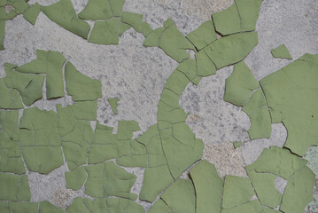 Old green paint falling off the wall