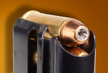 Hollow point bullet up close in a magazine
