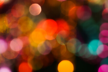 Fototapeta premium Vibrant abstract background with bright colorful bokeh defocused lights and creative illustration design. Festive pink and orange flickering blurred lights with dark shadow on backdrop