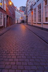 Fototapeta na wymiar Cityscape small northern european city. Stone street with old houses and buildings. Breda, Netherlands