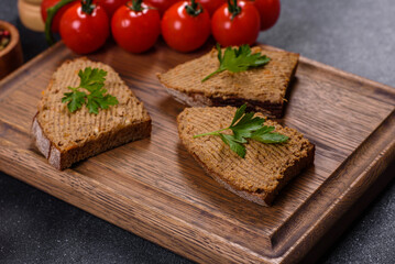 Appetizer, baguette with liver paste and herbs, closeup. Homemade breakfast