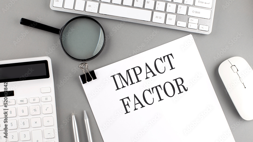 Poster impact factor written on paper with office tools and keyboard on the grey background