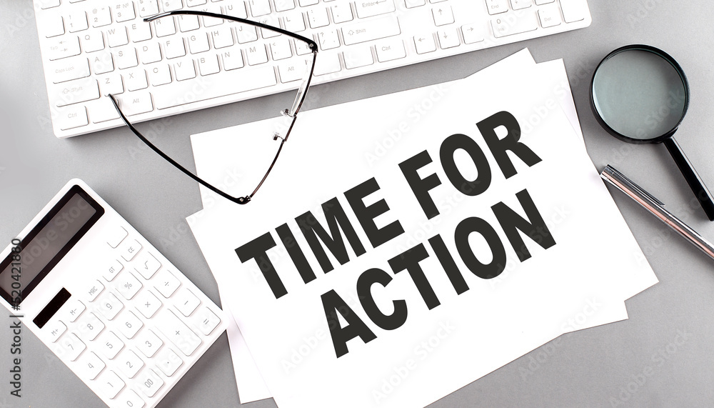 Aufkleber time to action text on paper with keyboard, calculator on grey background
