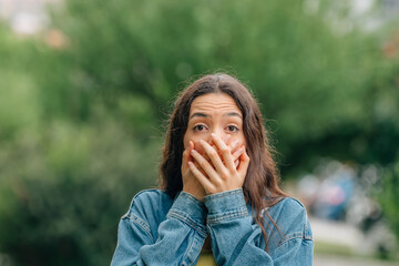 girl covering her mouth with expression of astonishment or surprise