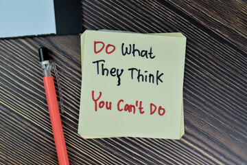 Concept of Do What They Think You Can't Do write on sticky notes isolated on Wooden Table.