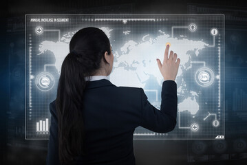Young business lady works with virtual graphic interface in futuristic office