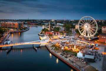 Ferris wheel in Gdansk by the Motlawa River at sunset, Poland