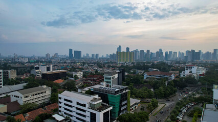 Aerial view of office buildings in Jakarta central business district and noise cloud when sunset. 