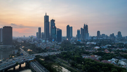 Aerial view of office buildings in Jakarta central business district and noise cloud when sunset. Jakarta, Indonesia, August 1, 2022