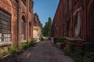 Plakat An abandoned old factory made of red bricks - a spinning mill in Poland