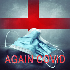 Lettering Again Covid and a crumpled medical mask on the flag of England. Return of the...