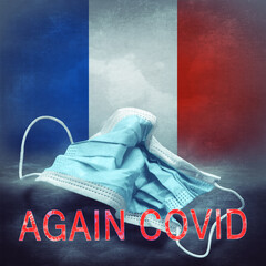 Lettering Again Covid and a crumpled medical mask on the flag of France. Return of the coronavirus....