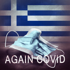 Inscription Again Covid and a crumpled medical mask on the flag of Greece. Return of the...