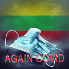 Lettering Again Covid and a crumpled medical mask on the flag of Lithuania. Return of the...
