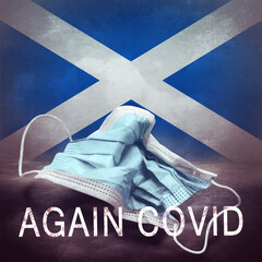 Inscription Again Covid and a crumpled medical mask on the flag of Scotland. Return of the...
