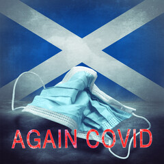 Lettering Again Covid and a crumpled medical mask on the flag of Scotland. Return of the...