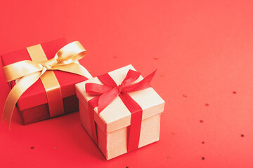 Fototapeta premium Two gifts boxes on red background, top view. New Year, Christmas concept