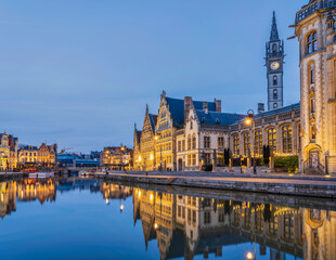 Historic medieval building at dusk on Leie river in Ghent, Belgium