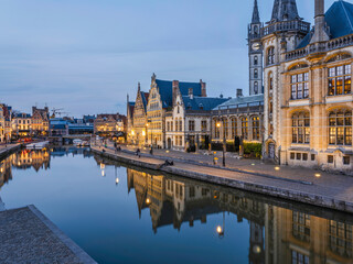 Naklejka na ściany i meble Historic medieval building at dusk on Leie river in Ghent, Belgium