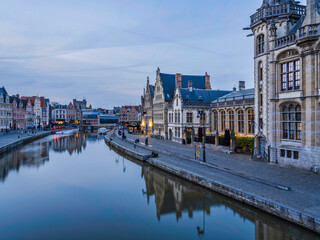 Historic medieval building during sunset on Leie river in Ghent, Belgium