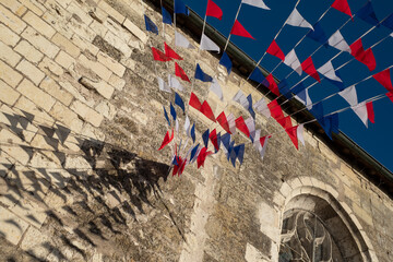 Red, white and blue bunting flags, blowing in the wind in the town of Amboise, Loire Valley, France. 