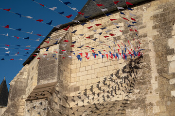 Red, white and blue bunting flags, blowing in the wind in the town of Amboise, Loire Valley,...